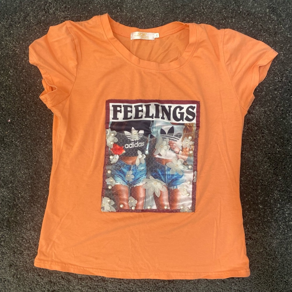 Orange tee, adidas logo with random fashion design. Super cute.